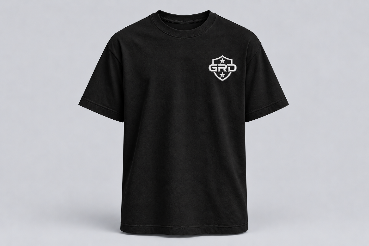 Front of the black GRD T-shirt with the two-star shield embroidered on the left chest